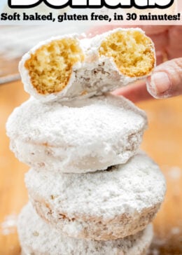 Pinterest pin with a stack of powdered sugar donuts and a hand taking the top 1/2 of a donut.
