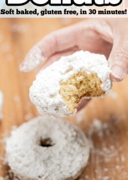 Pinterest pin with a hand holding a powdered sugar donut with a bite taken out of it.