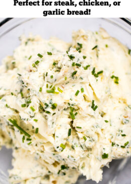 Pinterest pin with roasted garlic herb butter in a clear glass bowl.