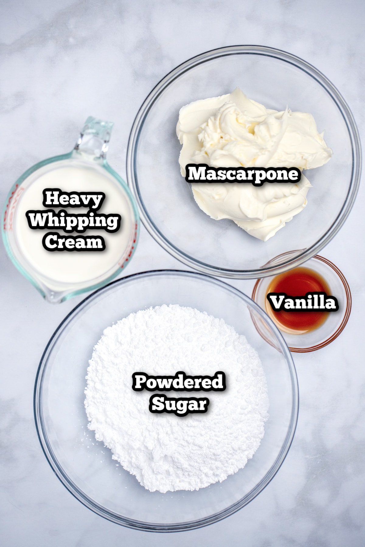 Individual ingredients for mascarpone frosting on a table.