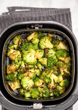 Air fryer basket full of broccoli.
