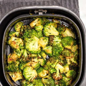 Air fryer basket full of broccoli.