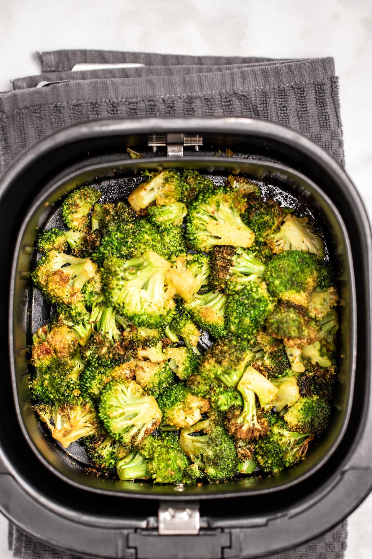 Air fryer basket full of broccoli.