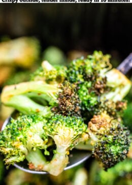 Pinterest pin with a spoonful of broccoli over an air fryer basket.