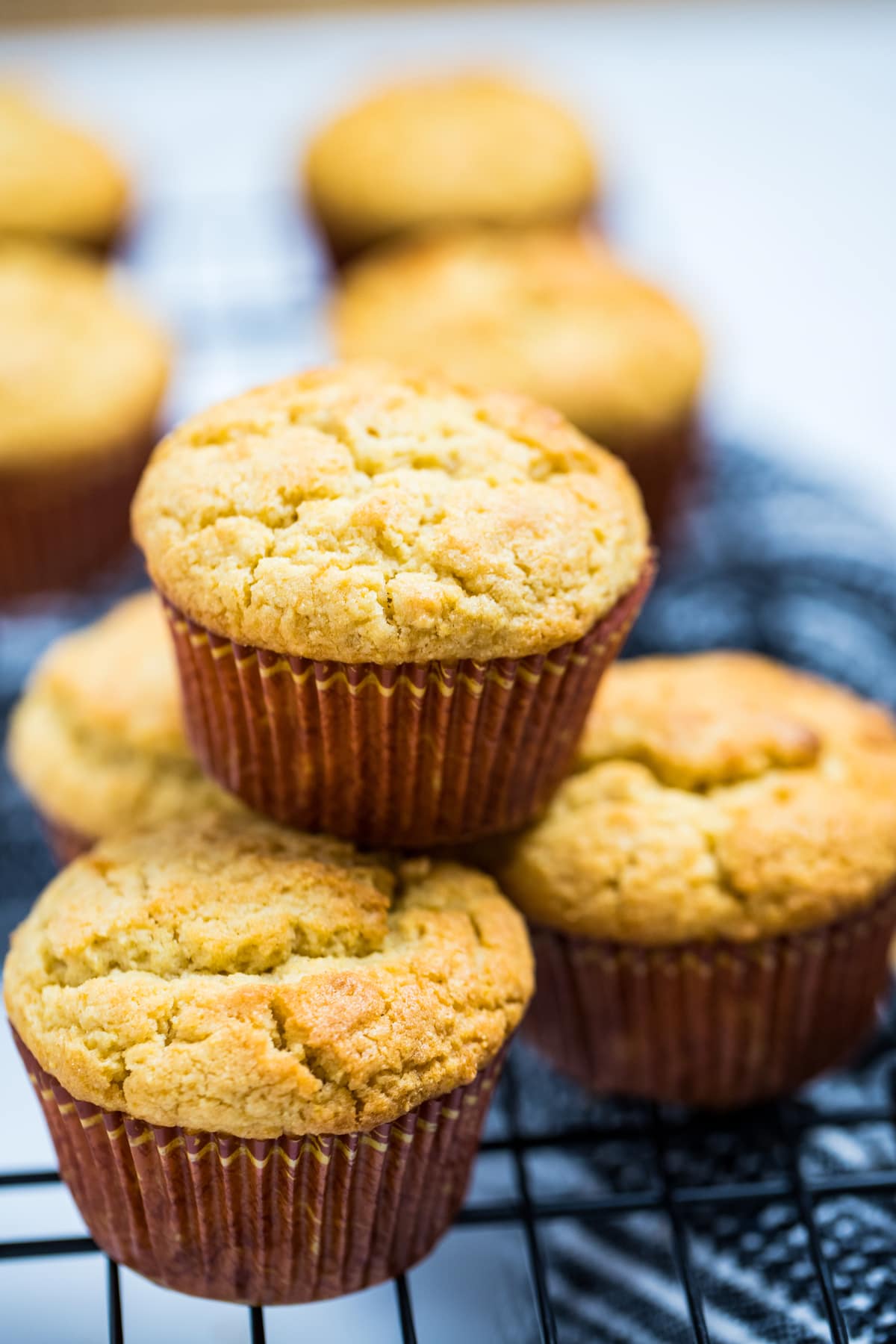 A corn muffin sitting on top of other corn muffins.