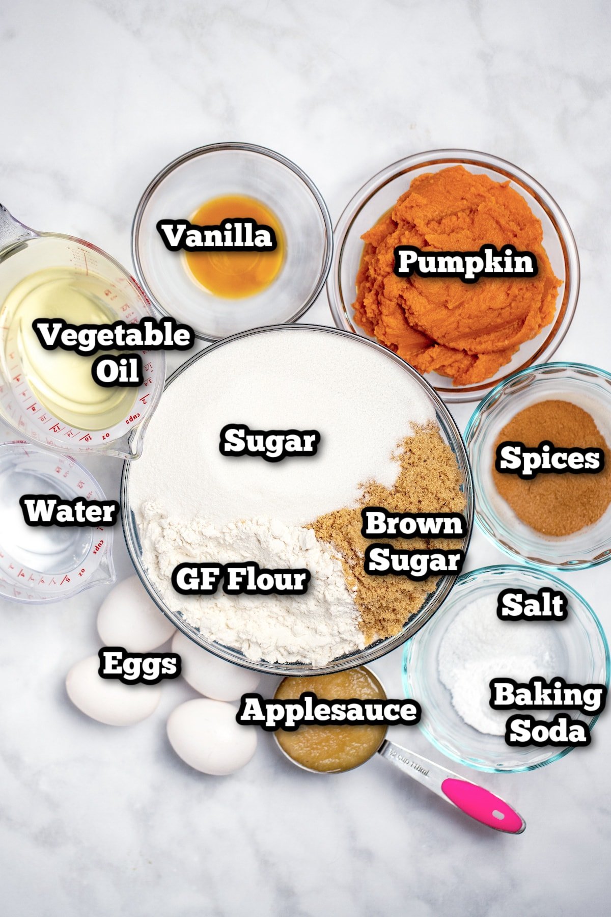 Individual ingredients for gluten free pumpkin bread on a table.