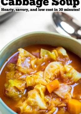 Pinterest pin with a bowl of cabbage soup next to a spoon.