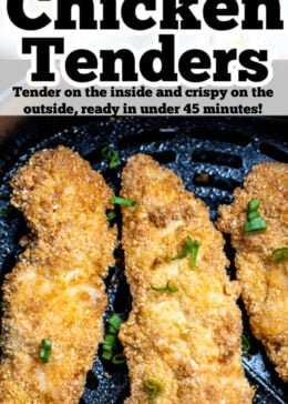 Pinterest pin with three air fryer chicken tenders sitting in the air fryer basket topped with green onion pieces.
