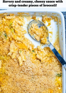 Pinterest pin of broccoli mac and cheese in a serving dish with a spoon sitting where part of the dish is empty.