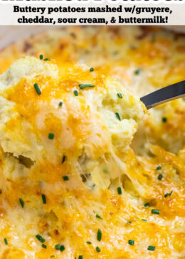 Pinterest pin with a spoon scooping cheesy mashed potatoes, with melty cheese pulling from the dish.