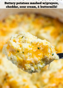 Pinterest pin with a spoon scooping cheesy mashed potatoes, with melty cheese pulling from the dish.