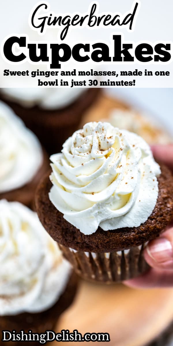 Pinterest pin with a hand holding a gingerbread cupcake topped with frosting above a wooden cutting board and other cupcakes.