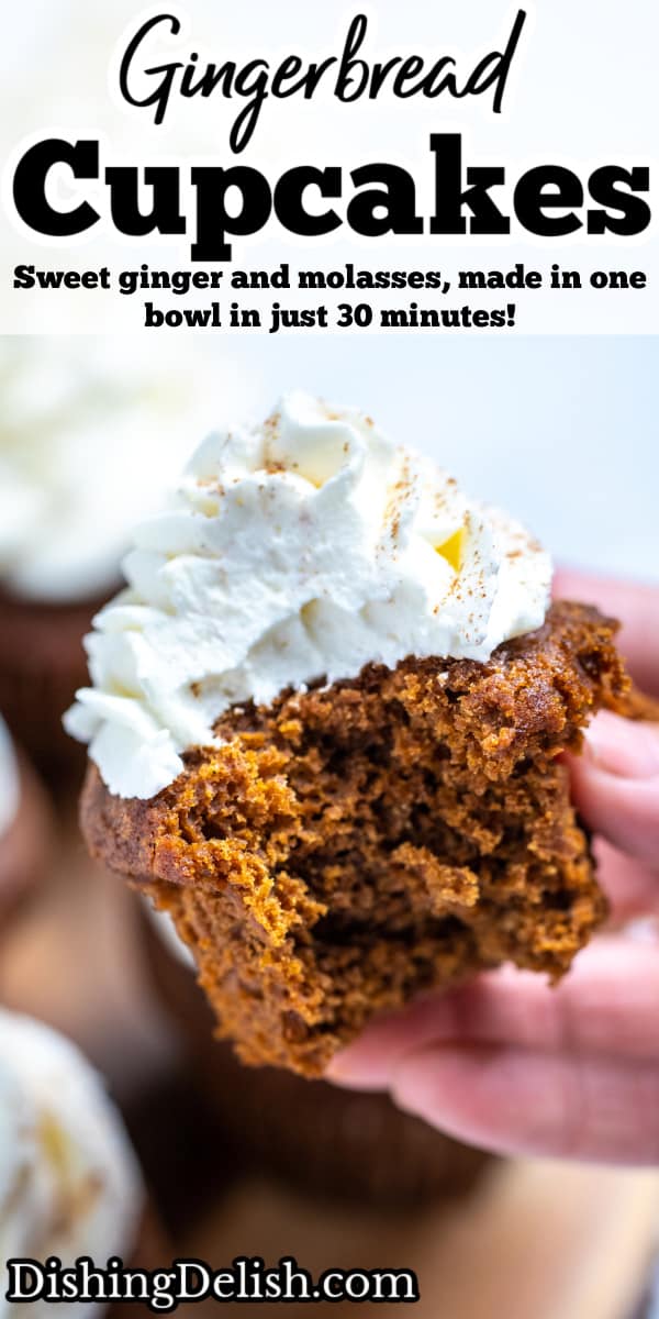 Pinterest pin with a hand holding a gingerbread cupcake topped with frosting with a bite taken out of it, above a wooden cutting board and other cupcakes.