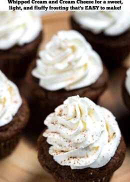 Pinterest pin with whipped cream cheese frosting decoratively piped onto gingerbread cupcakes, sitting on a wooden cutting board.