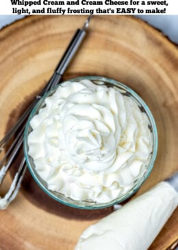 Pinterest pin with whipped cream cheese frosting piped into a glass bowl, with a whisk and a piping bag sitting on a wooden cutting board.