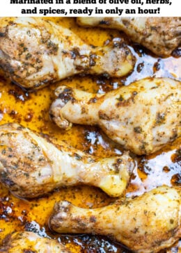 Pinterest pin with a baking dish with cooked chicken drumsticks covered in marinade.