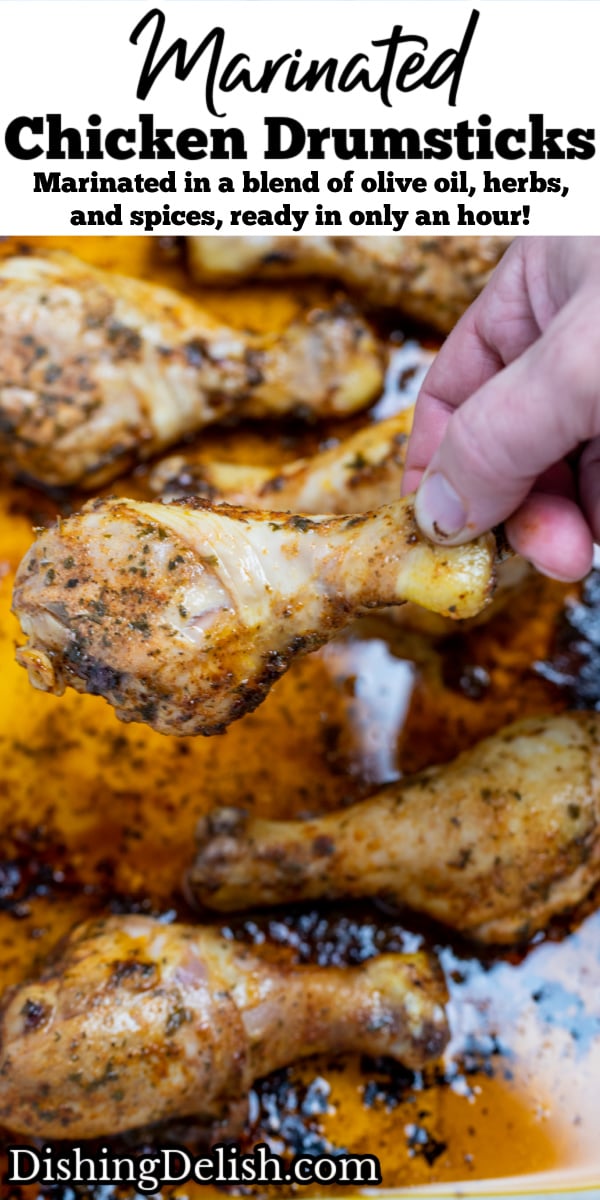 Pinterest pin with a baking dish with cooked chicken drumsticks covered in marinade and a hand taking a drumstick.