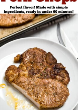 A marinated pork chop on a plate, next to a sheet pan with other cooked pork chops.