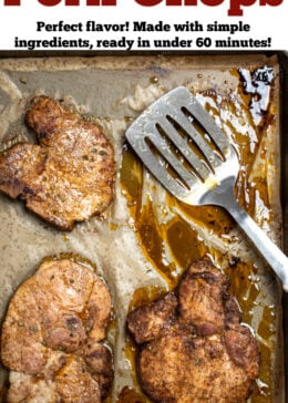 A pinterest pin with a sheet pan lined with parchment paper with cooked marinated pork chops, and a spatula in the upper right corner.