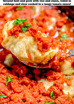 Pinterest pin with a spoon lifting a cabbage roll from the slow cooker topped with tomato sauce and fresh parsley.