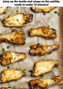 Pinterest pin with instant pot chicken wings on a sheet pan lined with parchment paper topped with green onions.