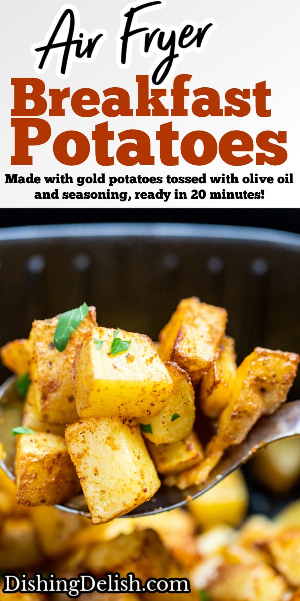 A spoon lifting air fryer breakfast potatoes out of an air fryer basket.