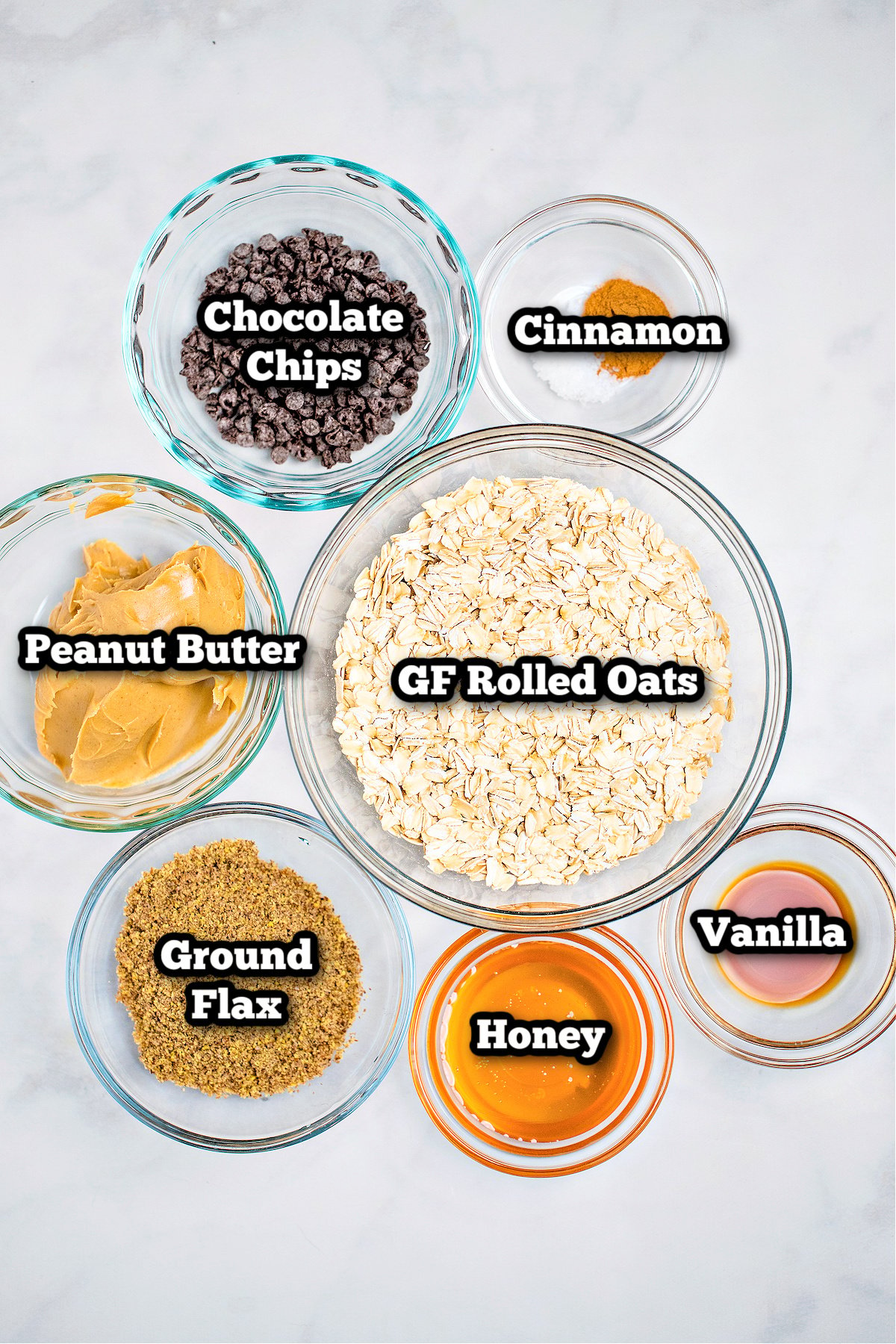 Individual ingredients for peanut butter oat balls on a table.