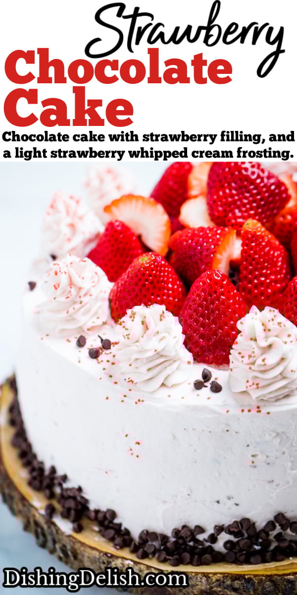 Pinterest pin with strawberry chocolate cake on a wooden cake stand, decorated with mini chocolate chips and frosting dolloped on top with fresh whole strawberries.