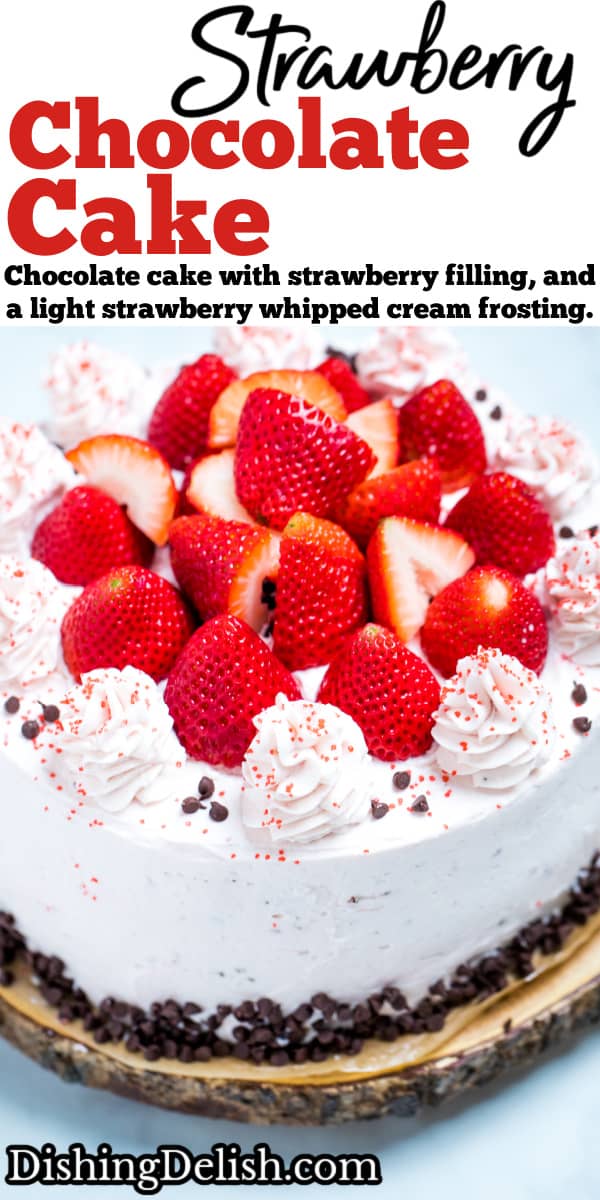 Pinterest pin with strawberry chocolate cake on a wooden cake stand, decorated with mini chocolate chips and frosting dolloped on top with fresh whole strawberries.