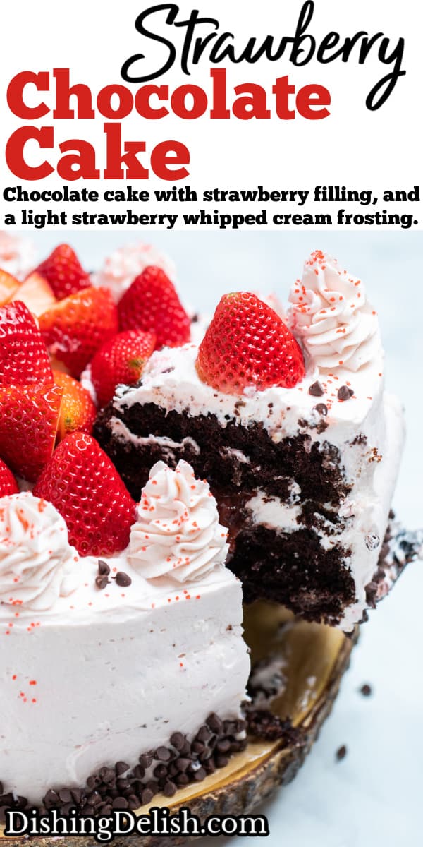 Pinterest pin with strawberry chocolate cake on a wooden cake stand, decorated with mini chocolate chips and frosting dolloped on top with fresh whole strawberries with a piece of cake being lifted up.