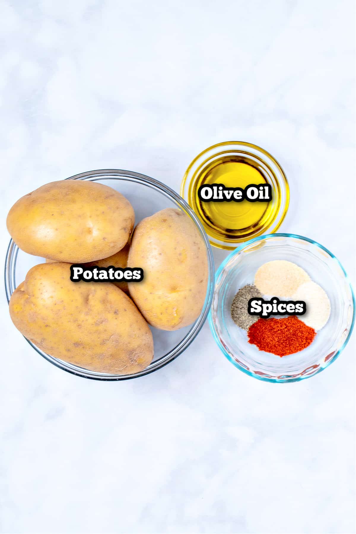 Individual ingredients for air fryer breakfast potatoes on a table.