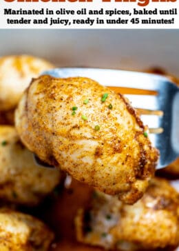 Pinterest pin with a baking dish of fully cooked chicken thighs sitting in chicken broth, with a spatula lifting one up, topped with seasoning and fresh chives.
