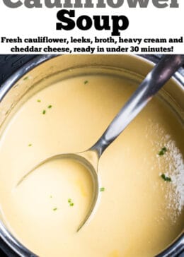 An instant pot with cauliflower soup topped with fresh chives and a ladle resting in the soup.