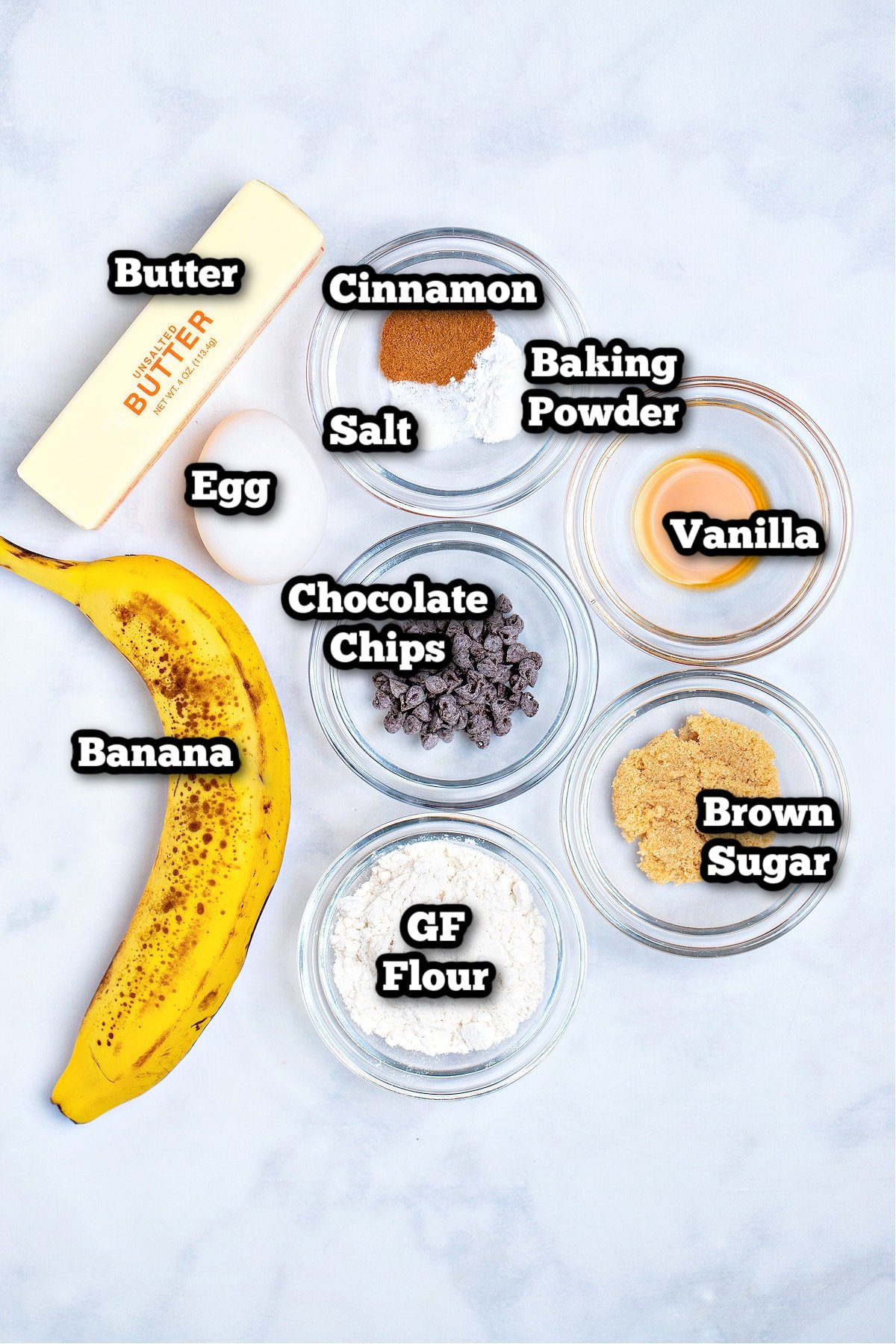 Individual ingredients for banana mug cake on a table.