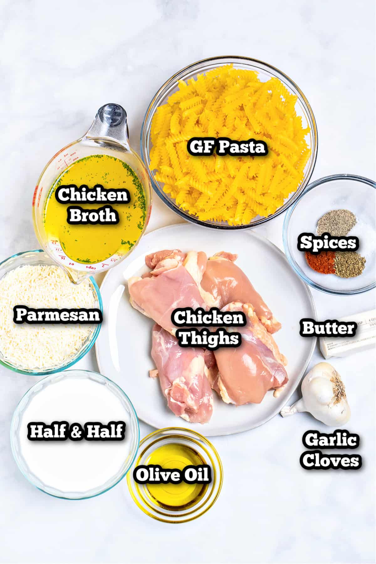 Individual ingredients for garlic parmesan chicken pasta on a table.