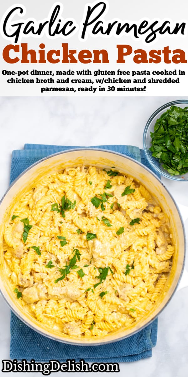 Pinterest pin with a dutch oven resting on a kitchen towel on the table, full of garlic parmesan chicken pasta topped with fresh parsley.