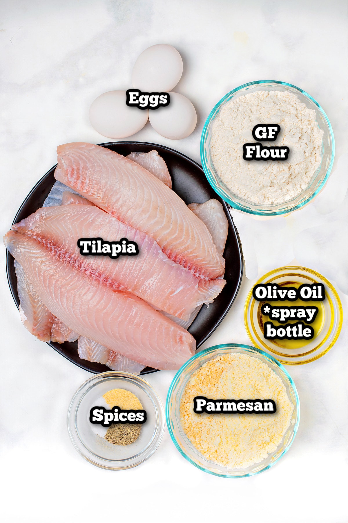 Individual ingredients for air fryer tilapia on a table.