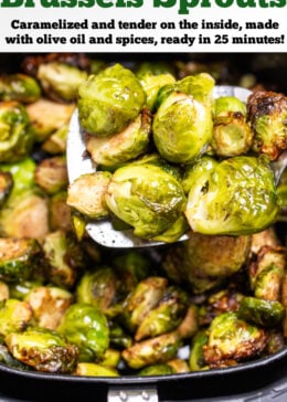 a spatula lifting Brussels sprouts out of an air fryer basket.