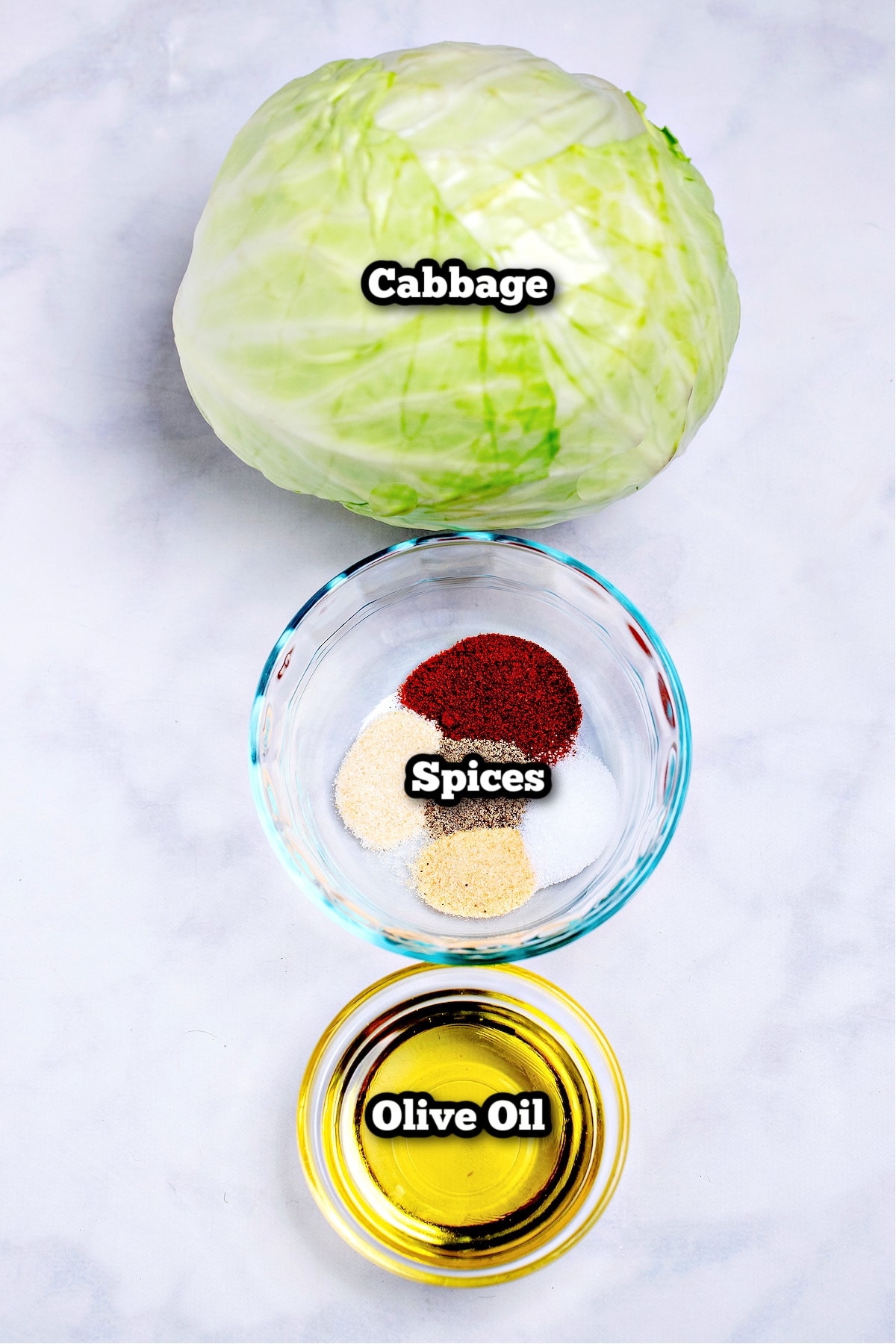 Individual ingredients for air fryer cabbage steak on a table.