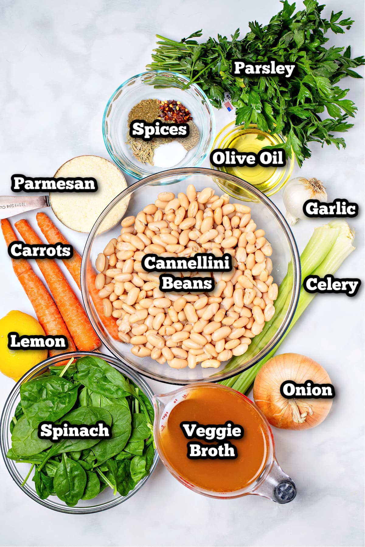 Individual ingredients for white bean soup on a table.