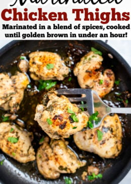 Pinterest pin with Greek marinated chicken thighs in a skillet topped with fresh parsley, with a spatula lifting a piece of chicken up.