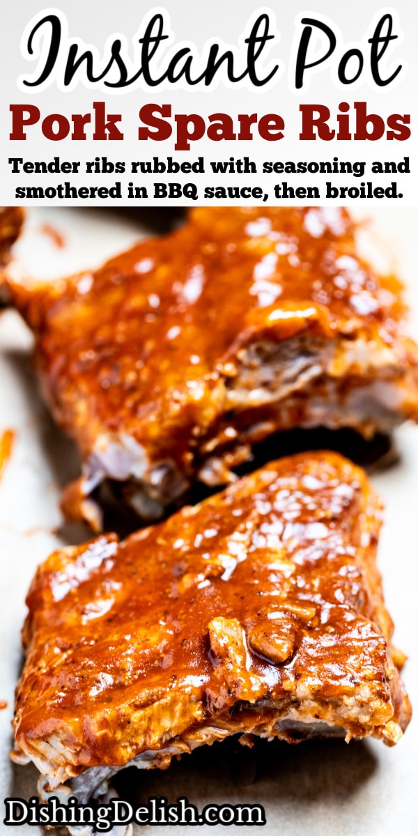 Pinterest pin with a section of pork spare ribs smothered in bbq sauce on a piece of parchment paper on a cutting board, with more sections of ribs in the background.