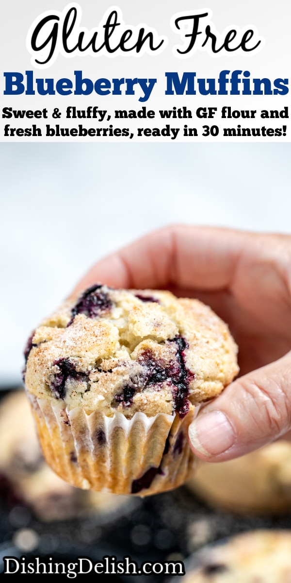 Pinterest pin with a hand holding a gluten free blueberry muffin above the tray of muffins.