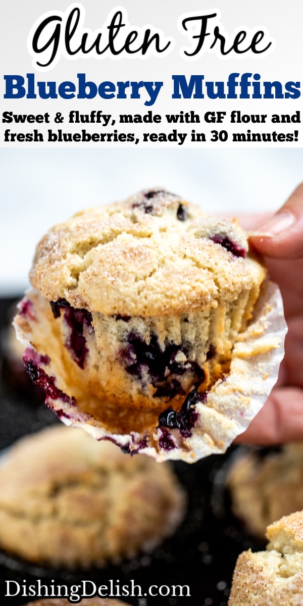 Pinterest pin with a hand holding a gluten free blueberry muffin above the tray of muffins, with half of the paper liner taken off.