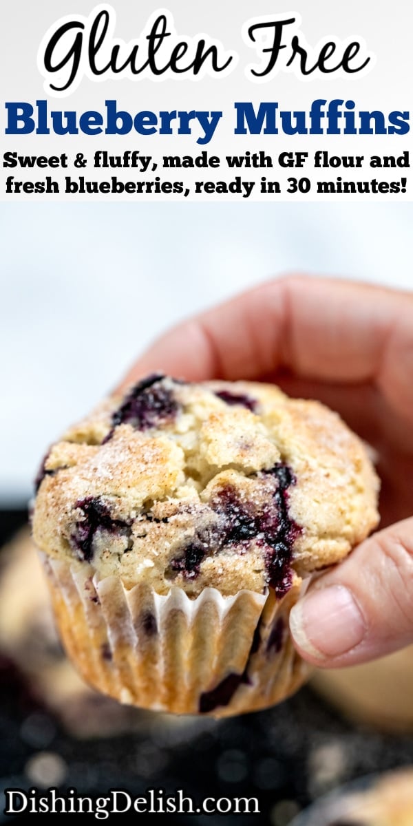 Pinterest pin with a hand holding a gluten free blueberry muffin above the tray of muffins.