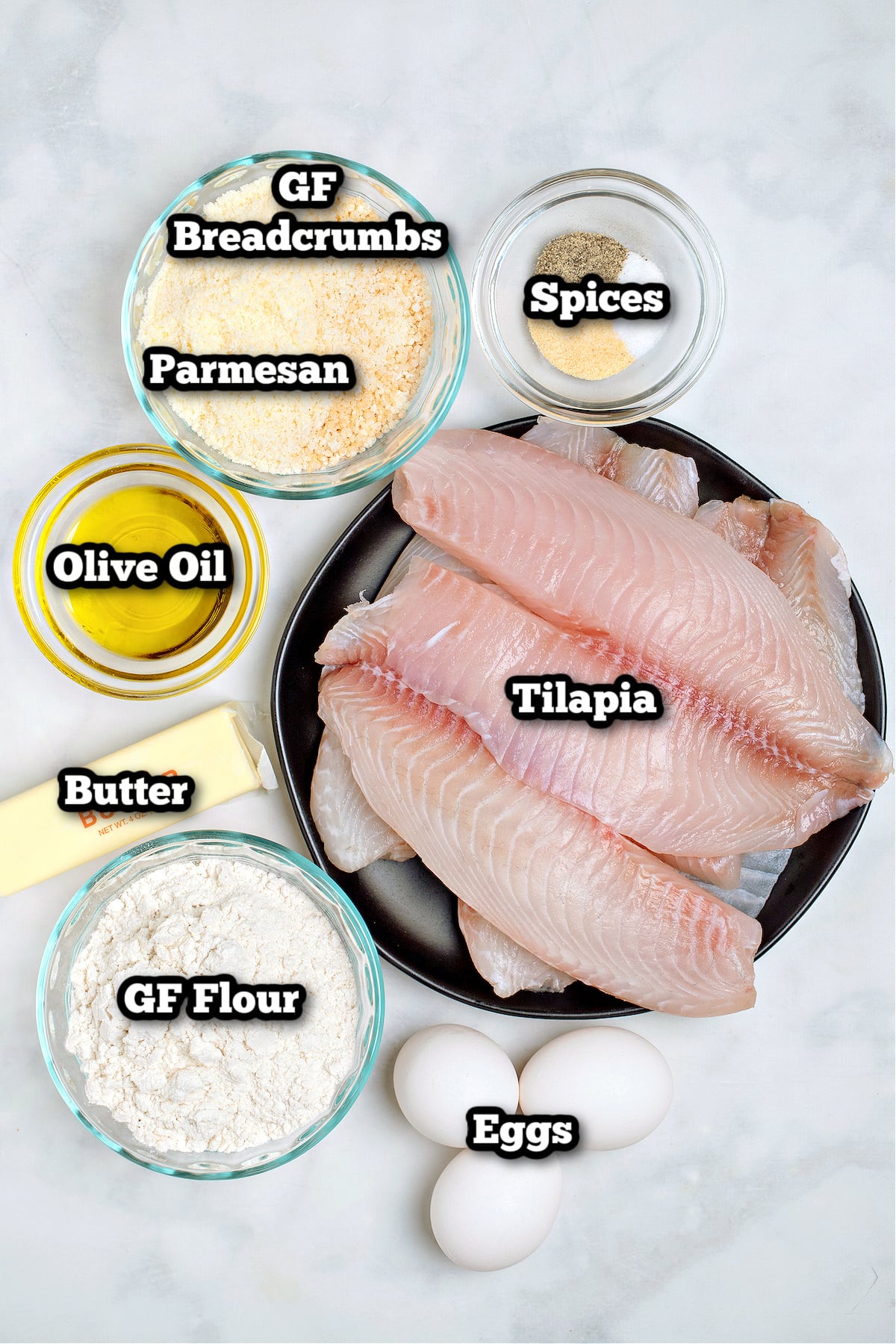 Individual ingredients for parmesan crusted tilapia on a table.