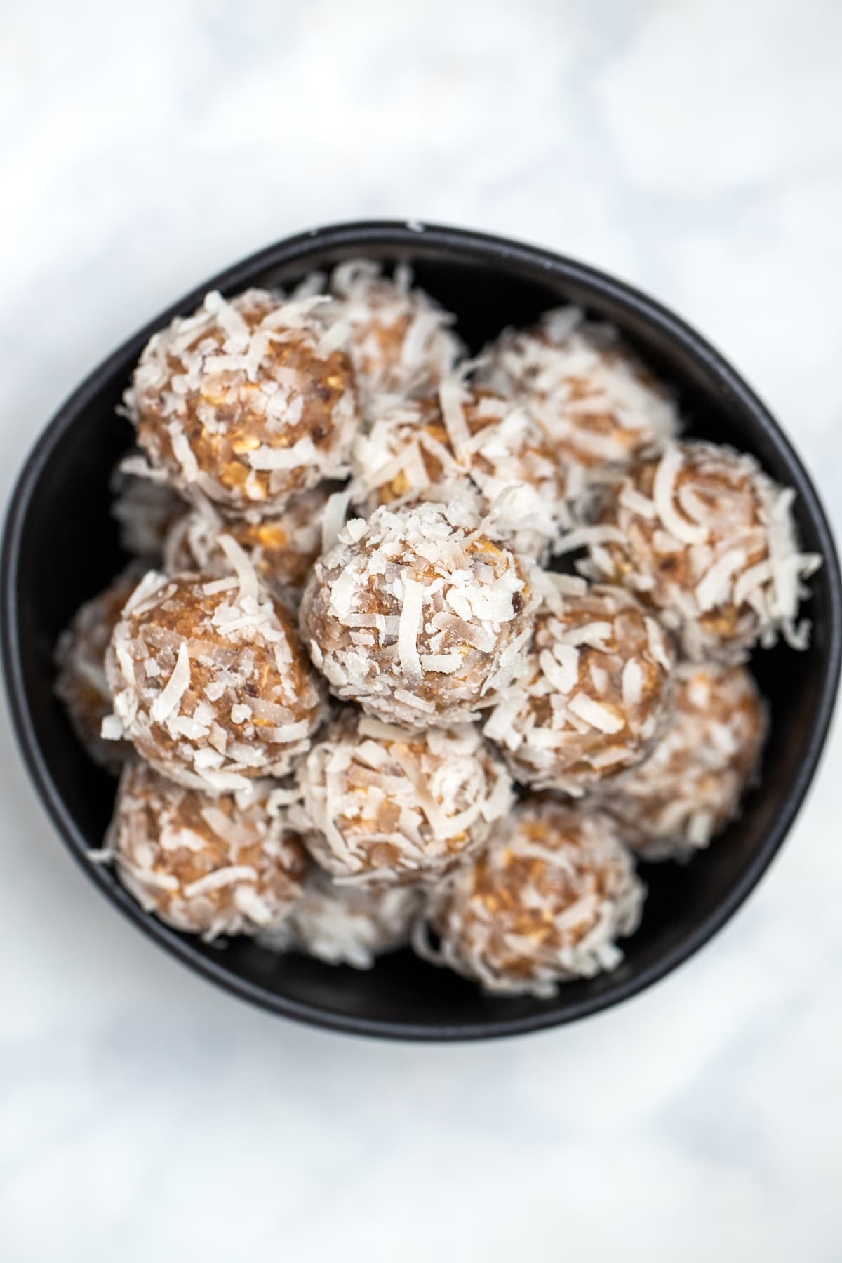 Peanut butter protein balls in a bowl on a table.