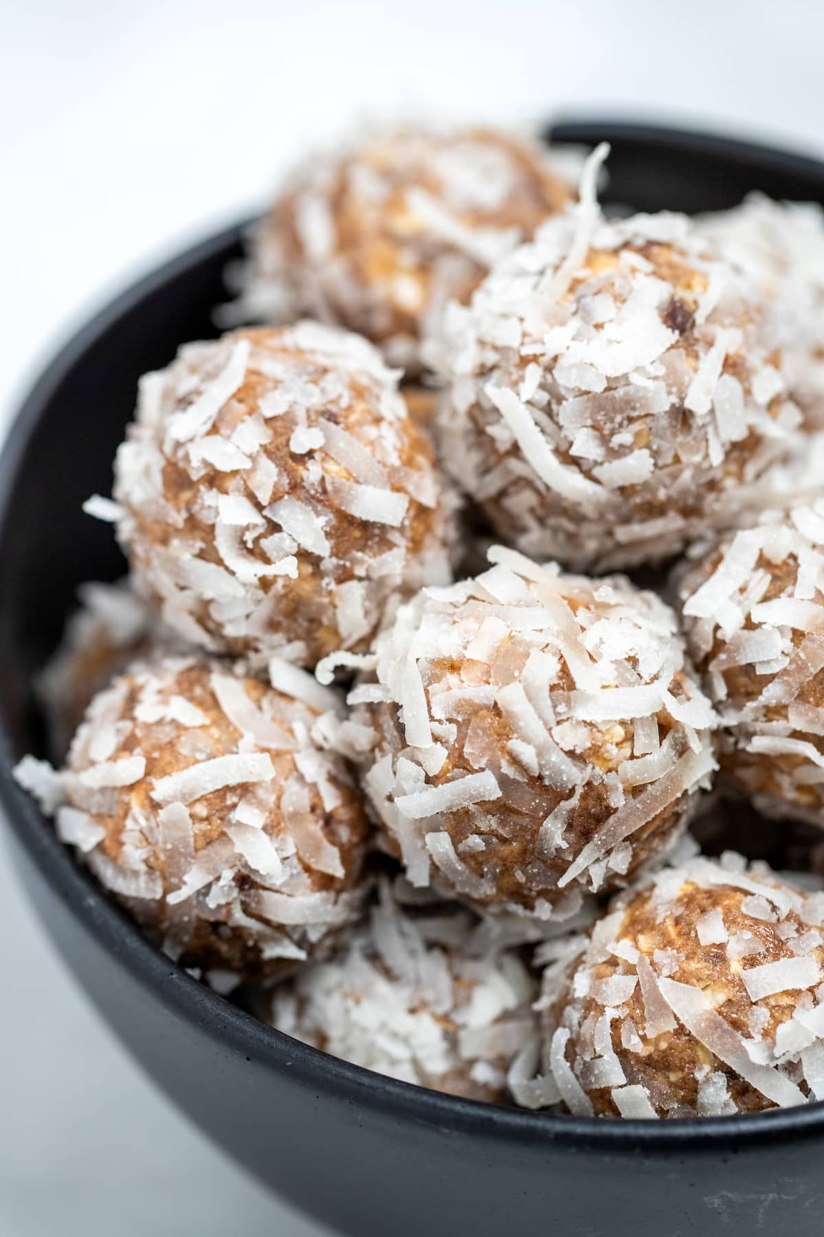 Peanut butter protein balls in a bowl on a table.