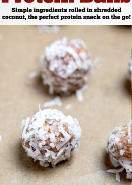 Pinterest pin with peanut butter protein balls on parchment paper on a sheet pan.