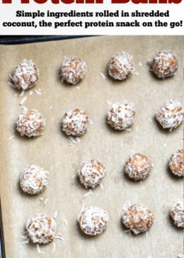 Peanut butter protein balls on a sheet pan with parchment paper.